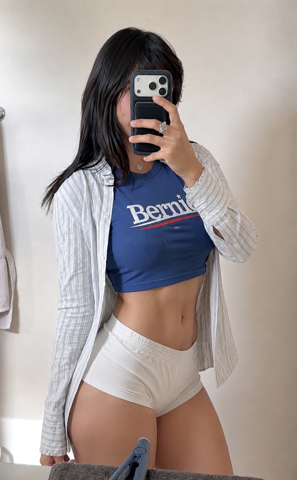 Mirror selfie of an unidentified woman in a blue Bernie shirt and white underwear, face obscured by a smartphone.