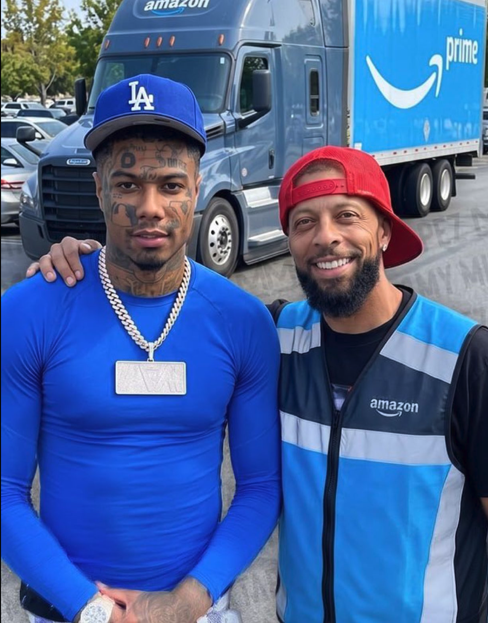 A man resembling Blueface posing beside a man in an Amazon delivery vest in front of an Amazon Prime semi-truck.