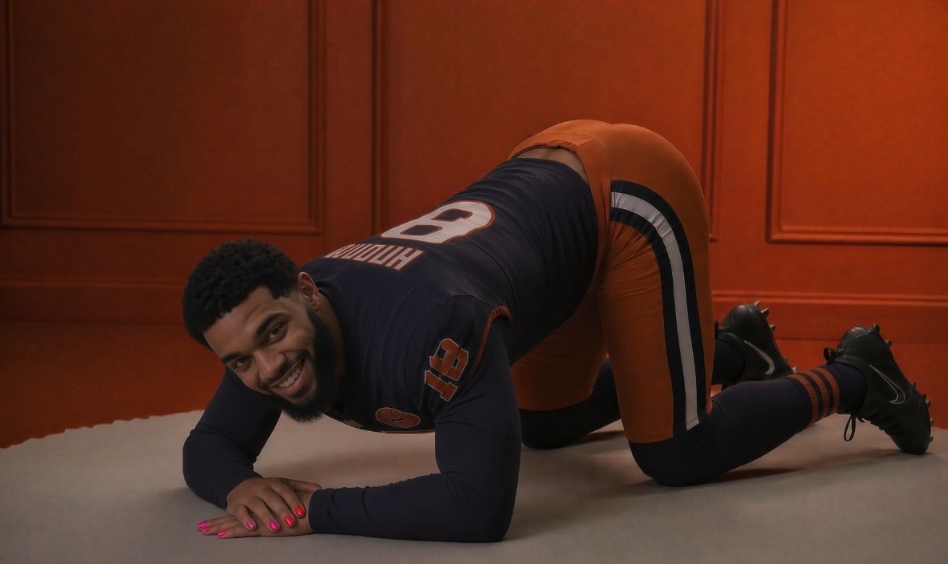 A man resembling Caleb Williams kneeling on a floor in a Bears uniform with painted fingernails.