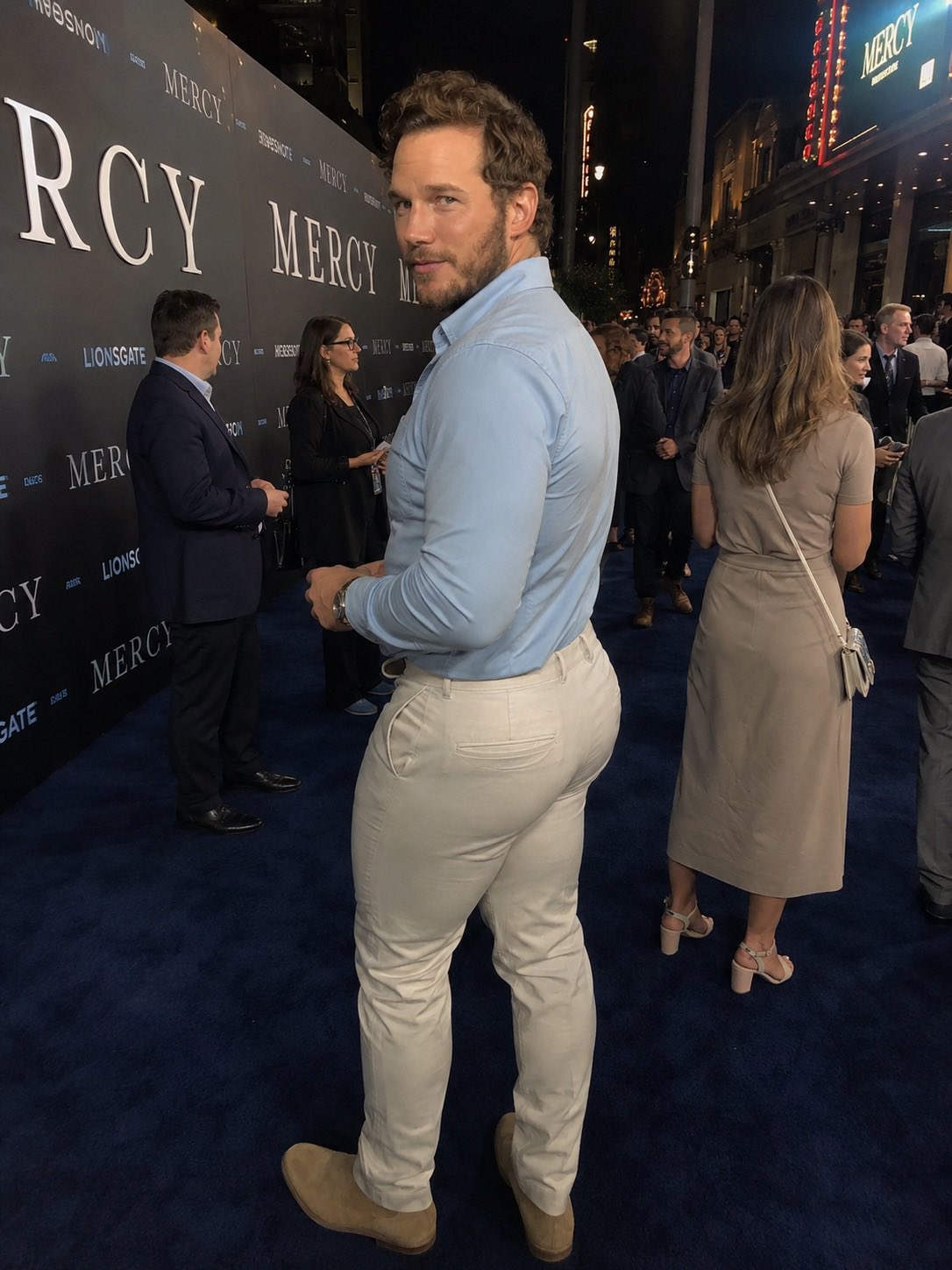 A man resembling Chris Pratt in a light blue shirt and cream pants at the Mercy movie premiere.