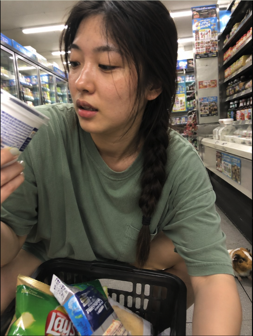 A woman browsing items in a convenience store.