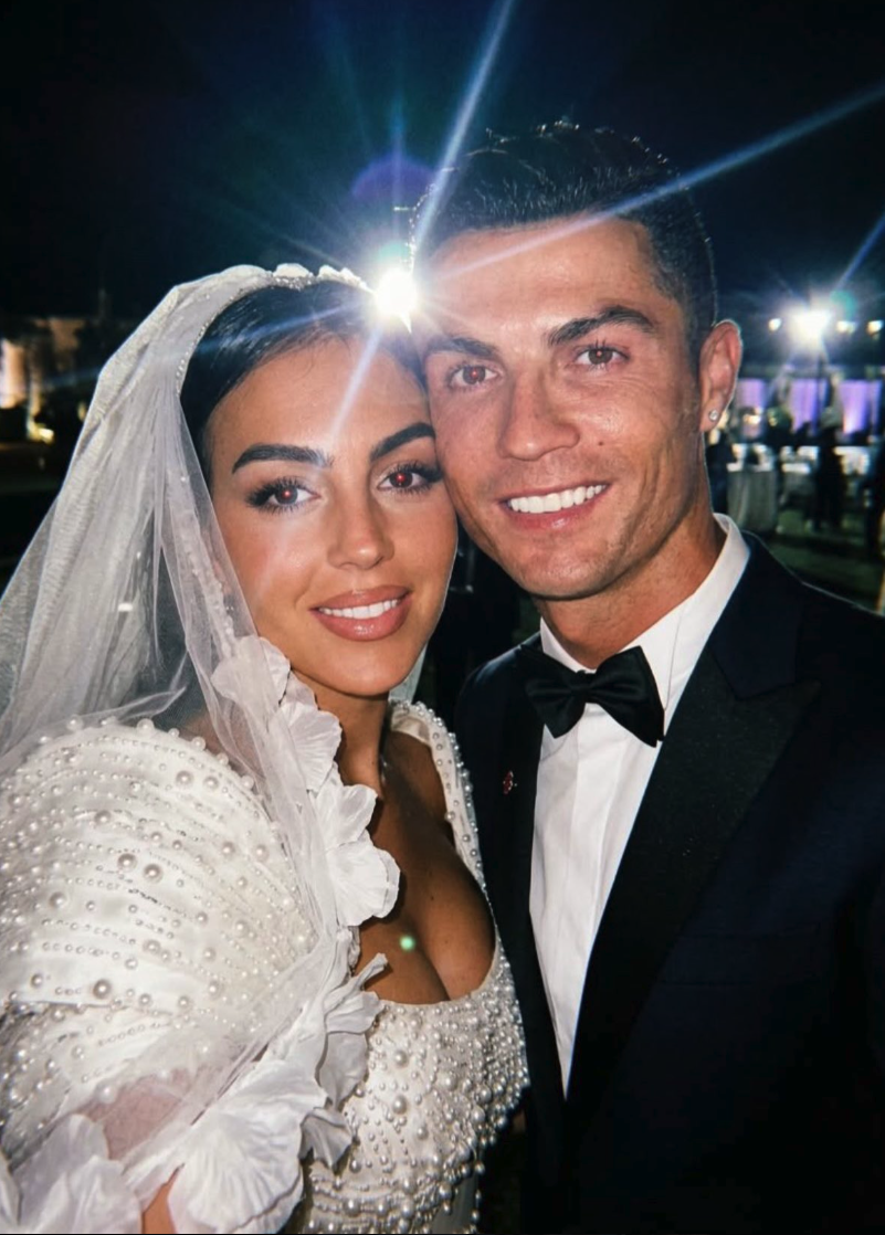 A man resembling Cristiano Ronaldo in a black tuxedo posing with an unidentified woman in a white bridal gown and veil.