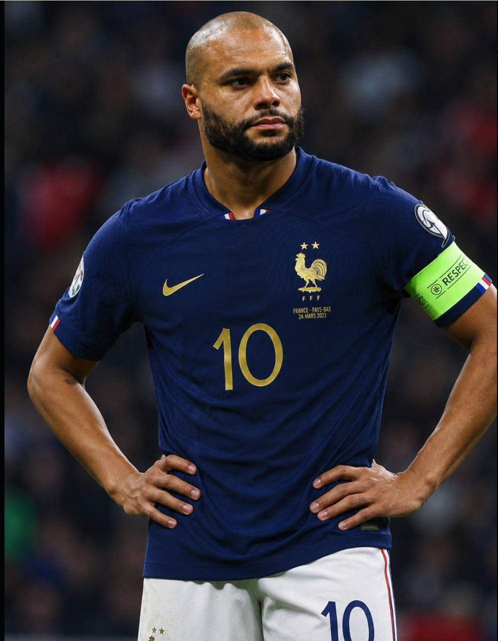 A man resembling Dak Prescott wearing a dark blue France national team #10 jersey with a captain's armband.