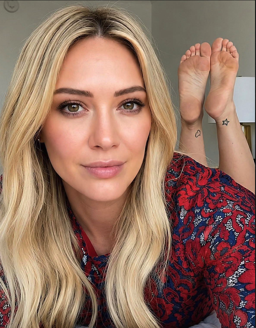 A woman resembling Hilary Duff lying down with bare feet raised behind her head.