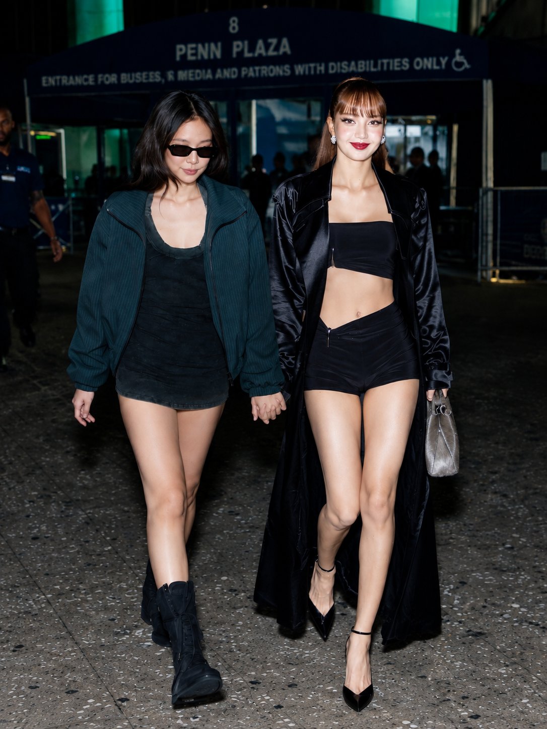 Two women resembling Jennie and Lisa walking together on a city sidewalk at night.