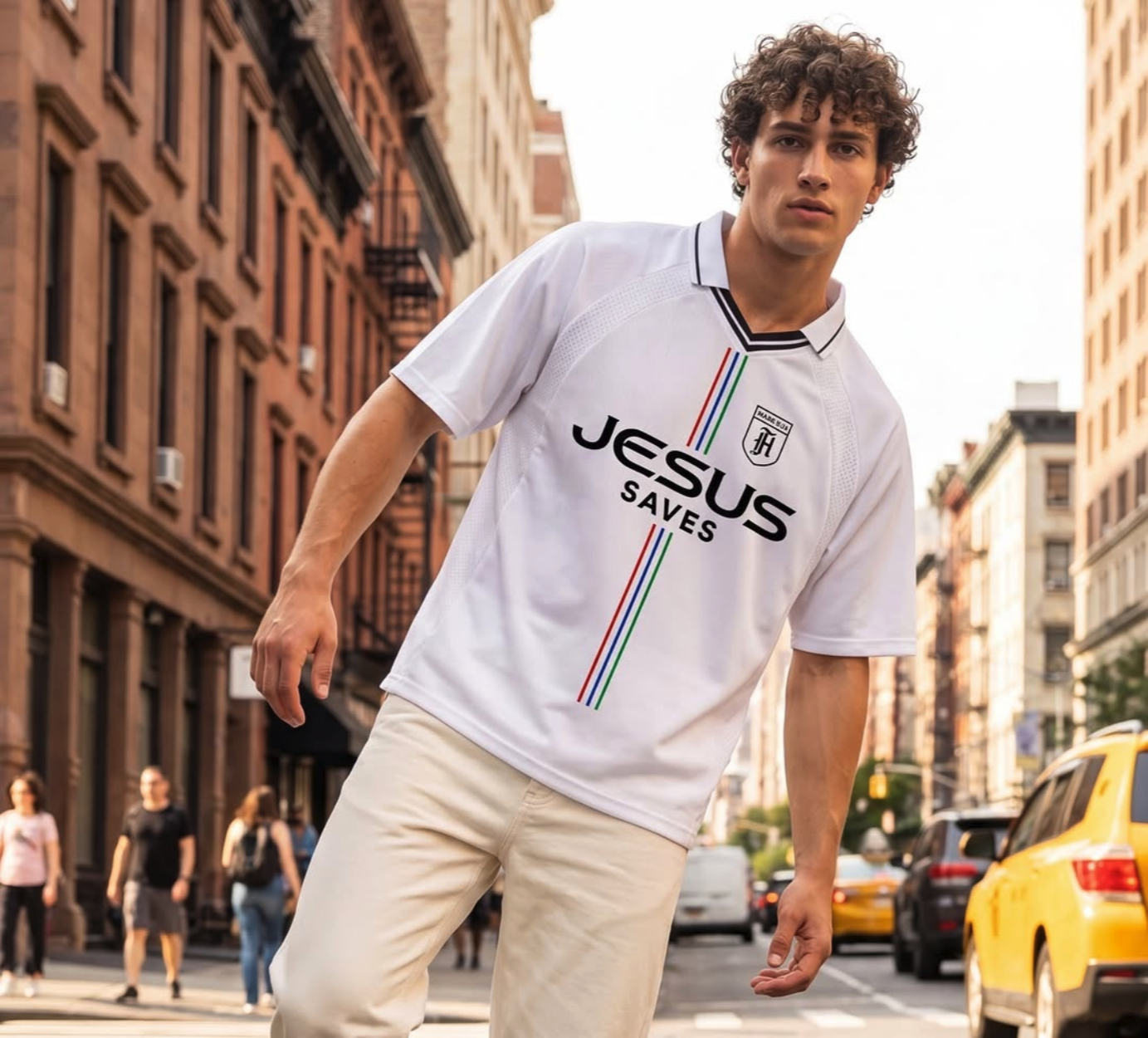 A young man with curly hair wearing a white "Jesus Saves" football jersey on a city street beside a yellow taxi.