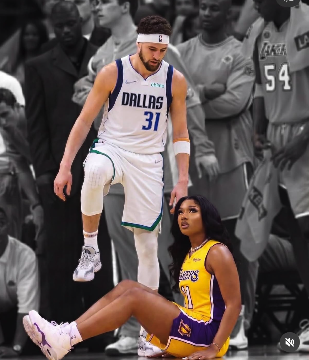 A man resembling Klay Thompson in a Dallas jersey standing over a woman in a Lakers jersey seated on a court.