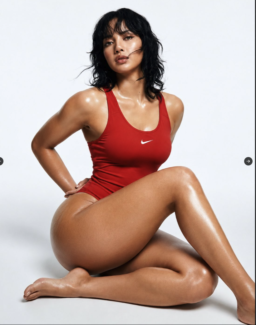 A woman resembling Lisa from BlackPink seated in a red Nike-branded bodysuit against a white backdrop.