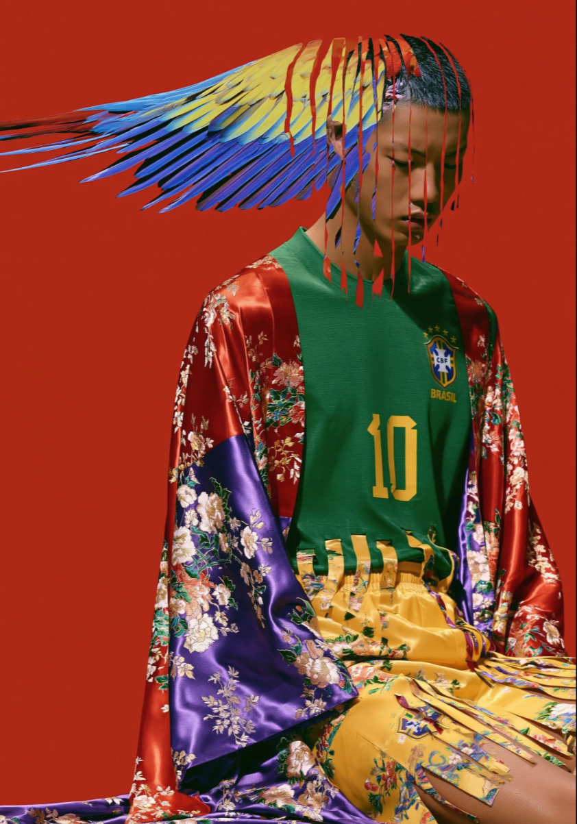 A man resembling Liu Kai in a Brazil #10 jersey, floral robe, and colorful feathered headdress against a red background.