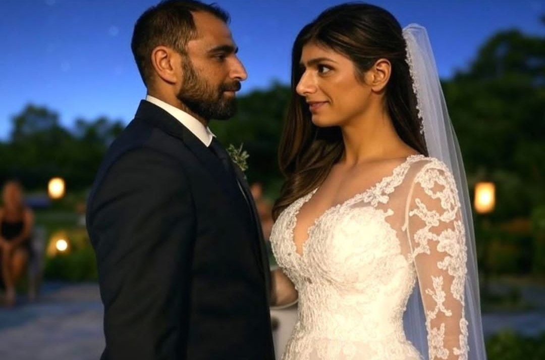 A man resembling Mohammad Shami in a dark suit standing beside a woman in a white lace wedding gown and veil at an outdoor evening event.