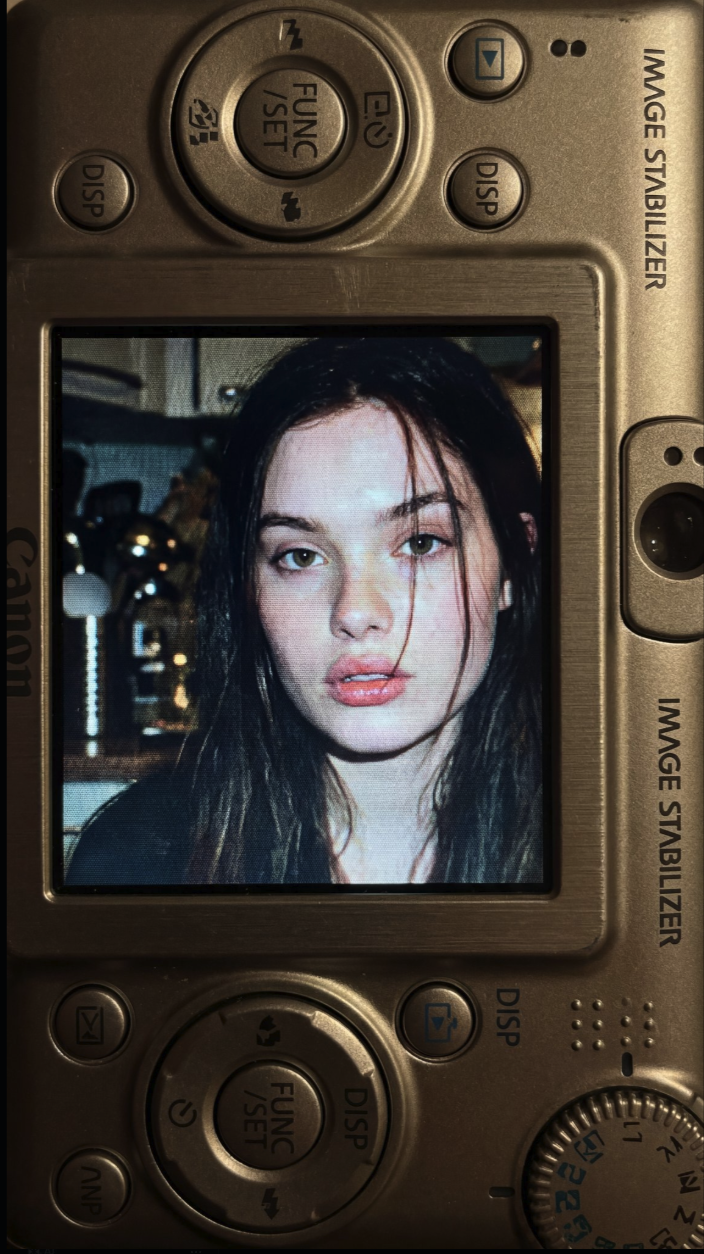 A young woman resembling Odeya Rush shown on a Canon camera LCD screen.