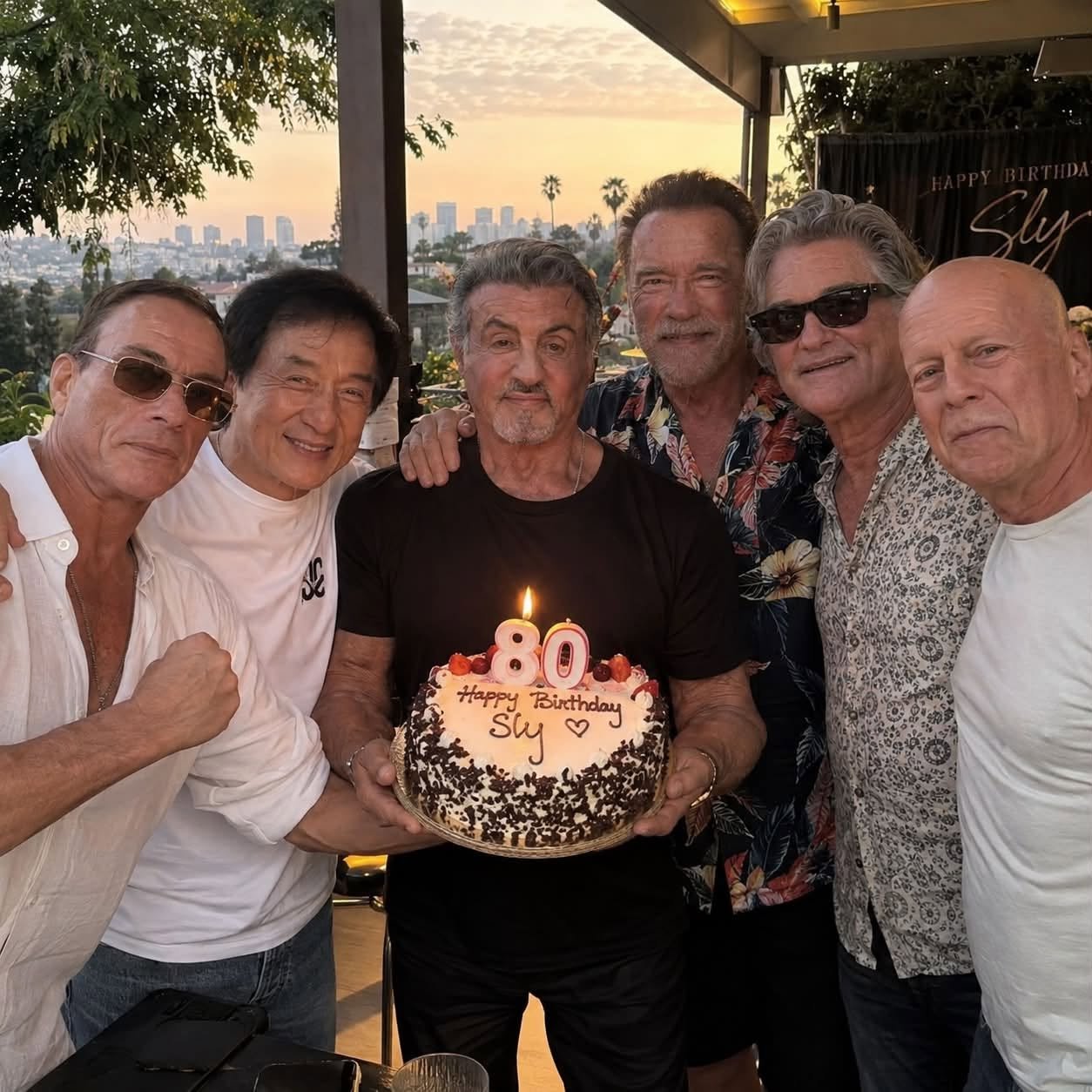 Six men resembling Sylvester Stallone, Arnold Schwarzenegger, Bruce Willis, Kurt Russell, Jackie Chan, and Jean-Claude Van Damme gathered around a birthday cake outdoors at sunset.