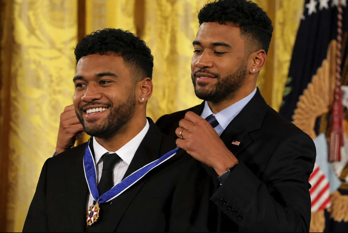 Two men resembling Tua Tagovailoa at a White House ceremony, one wearing a Presidential Medal of Freedom.