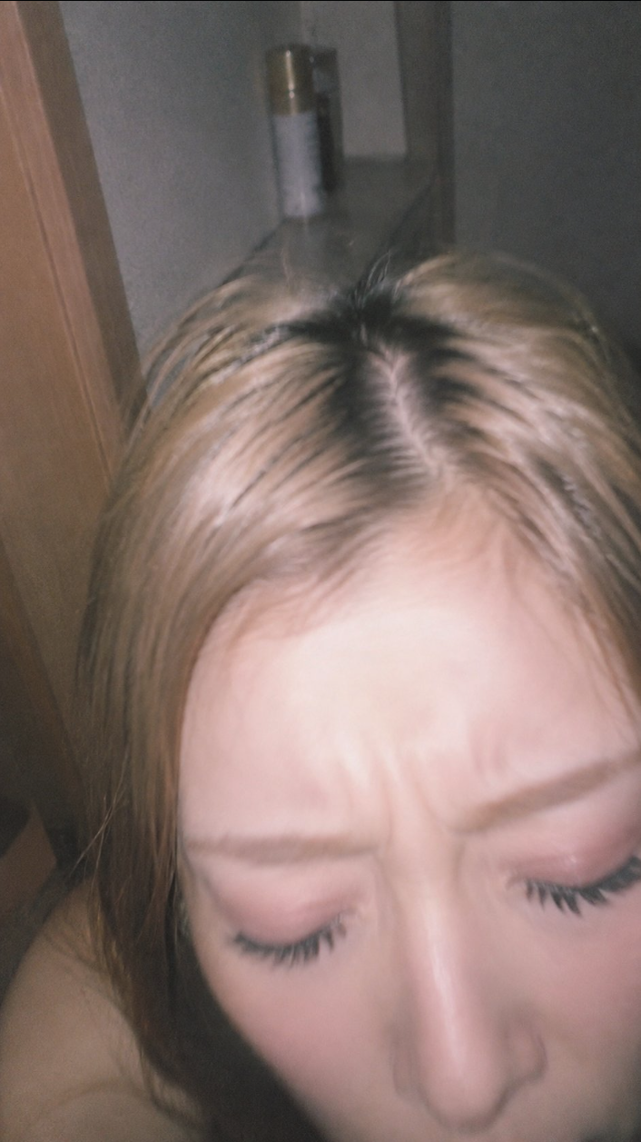 A close-up selfie showing the upper face and hair of an unidentified person with eyes closed.