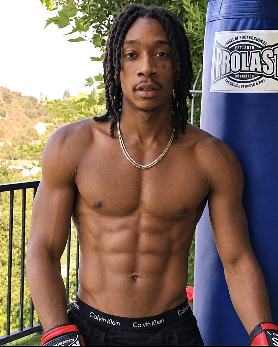 AI man resembling Wiz Khalifa in boxing gloves and no tattoos