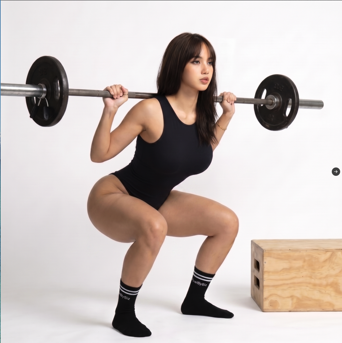 A woman resembling Lisa (BlackPink) performing a barbell back squat in a studio setting.