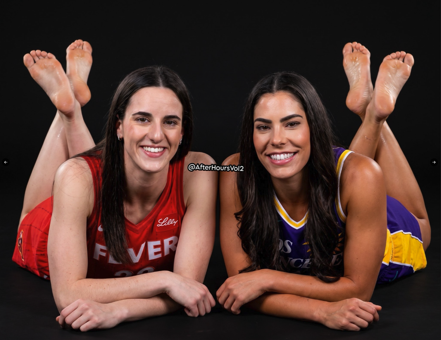 Two women resembling Caitlin Clark and Kelsey Plum lying on their stomachs in a studio, wearing WNBA jerseys.