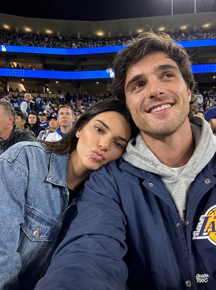 A man resembling Jacob Elordi and a woman resembling Kendall Jenner posing together at a Los Angeles Dodgers game.
