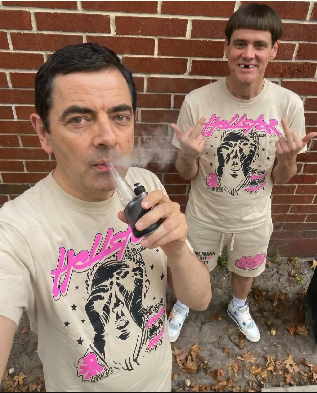 Two men resembling Rowan Atkinson and Jim Carrey in matching cream Hellstar t-shirts standing by a brick wall.
