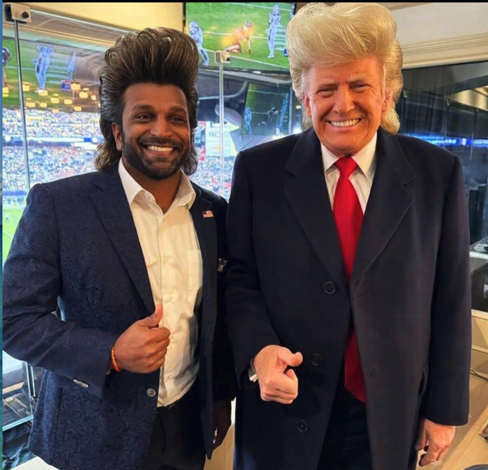 Two men resembling Kash Patel and Donald Trump posing together in a stadium suite with a football game visible on a screen behind them.