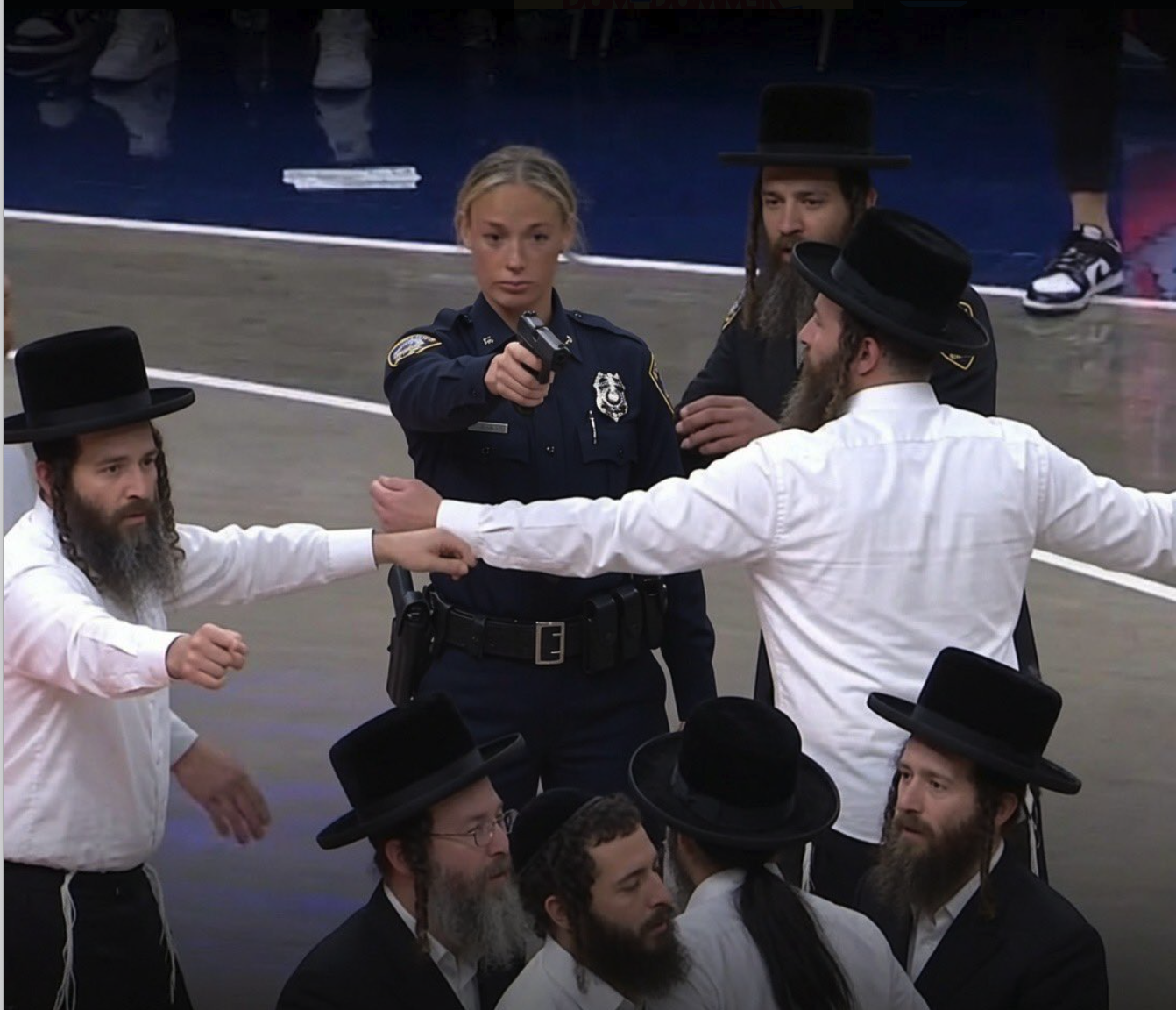 A woman resembling Sophie Cunningham in police uniform pointing a firearm, with men in Orthodox Jewish dress.