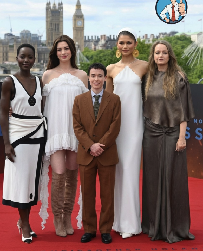 Five people resembling Lupita Nyong'o, Anne Hathaway, Elliot Page, Zendaya, and Jodie Foster posing on a red carpet.