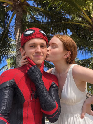 AI-generated image of Tom Holland in a Spider-Man costume being kissed on a beach