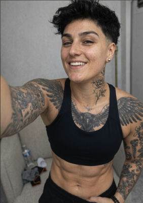 AI-generated selfie of an unidentified tattooed woman at a gym