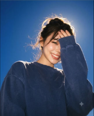 AI-generated portrait of a smiling woman against a blue sky