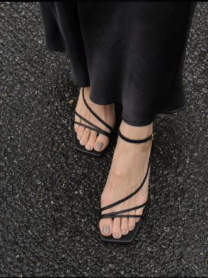 AI-generated image of feet in black strappy sandals