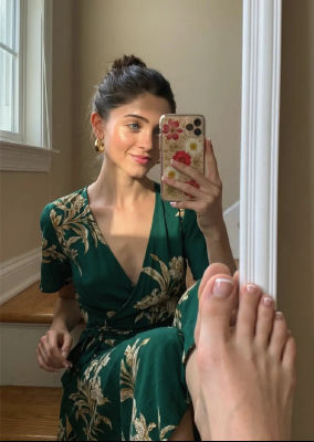 AI-generated selfie of Natalia Dyer in a green floral dress