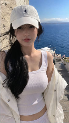 AI-generated image of a woman at a Mediterranean coastal viewpoint