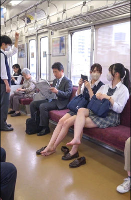 AI-generated image of schoolgirls seated barefoot on a Japanese train