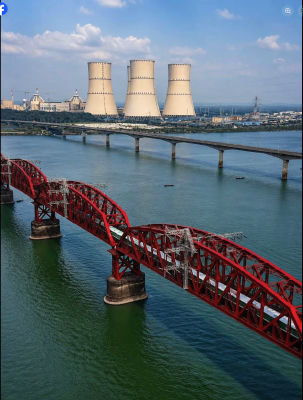 AI-generated image of cooling towers and red truss bridge over a river