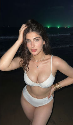 AI-generated photo of a woman in a white bikini on a beach at night