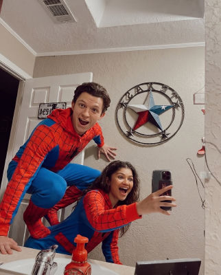 AI-generated image of Tom Holland and Zendaya in Spider-Man costumes taking a mirror selfie