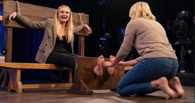 AI-generated image of Sophie Turner in a foot kissing studio scene