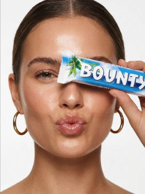 AI-generated beauty portrait of an unidentified woman holding a Bounty bar