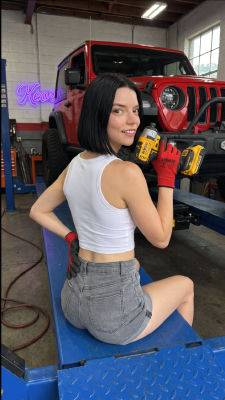 AI-generated image of Anya Taylor-Joy holding a power drill in an auto shop