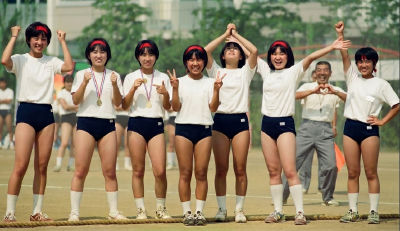 AI-generated image of seven young women posing on an outdoor field