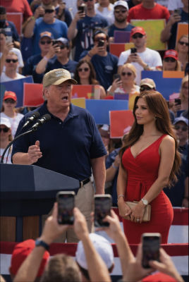 AI-generated image of Donald Trump speaking at a rally with a woman in a red dress