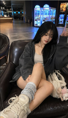 AI-generated image of a woman seated at an arcade