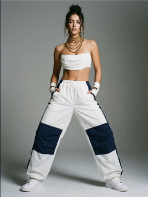 AI-generated image of a woman in white crop top and track pants