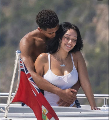 Reported AI-generated image of Jude Bellingham embracing a woman on a yacht wearing a '1win' necklaces