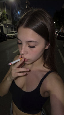 AI-generated image of an unidentified woman smoking on a night street
