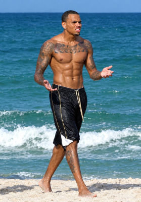 AI image detected of Chris Brown on a beach shrugging