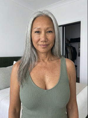 Reported AI-generated selfie of an unidentified woman in a green tank top