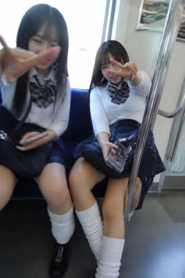 AI-generated image of two young women in school uniforms posing on a train