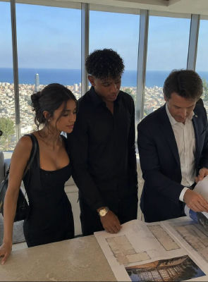 AI-generated image of Lamine Yamal and two other people  reviewing architectural plans in a high-rise apartment