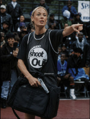 AI-generated image resembling Sophie Cunningham at a basketball court holding a pistol